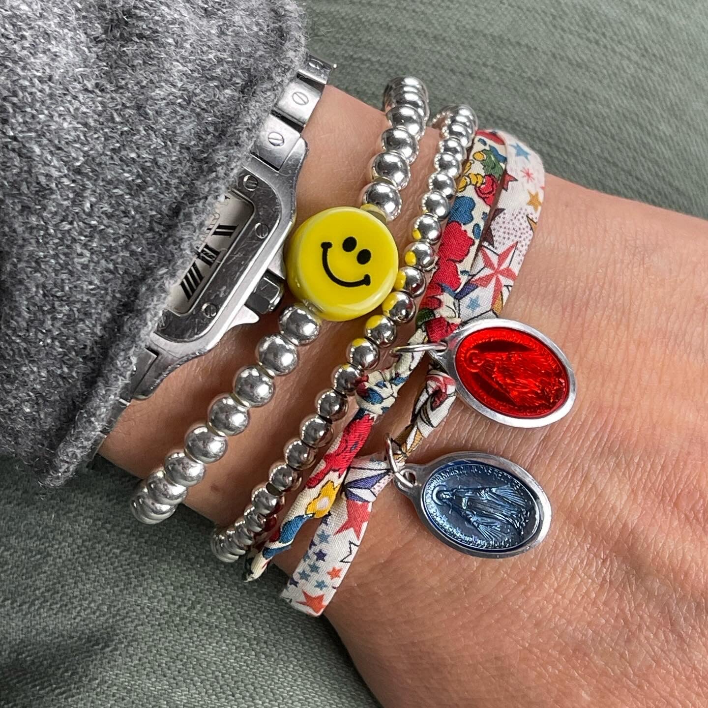 Sterling silver stretch bracelet with porcelain smiley bead