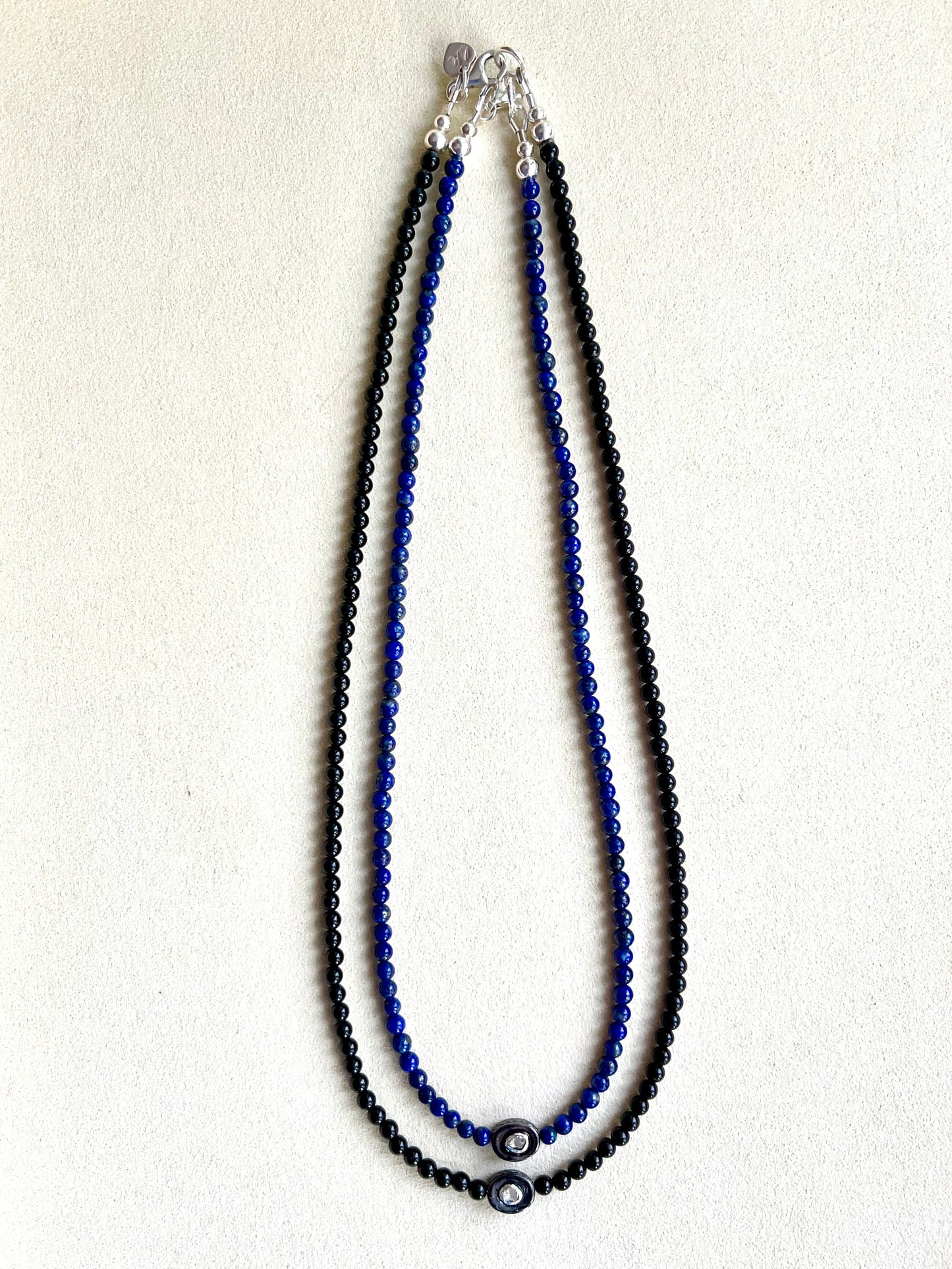 Necklace with an oxidized sterling silver pendant inset with a polki diamond