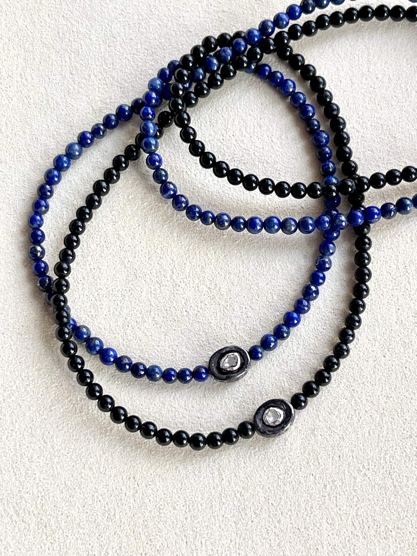 Necklace with an oxidized sterling silver pendant inset with a polki diamond